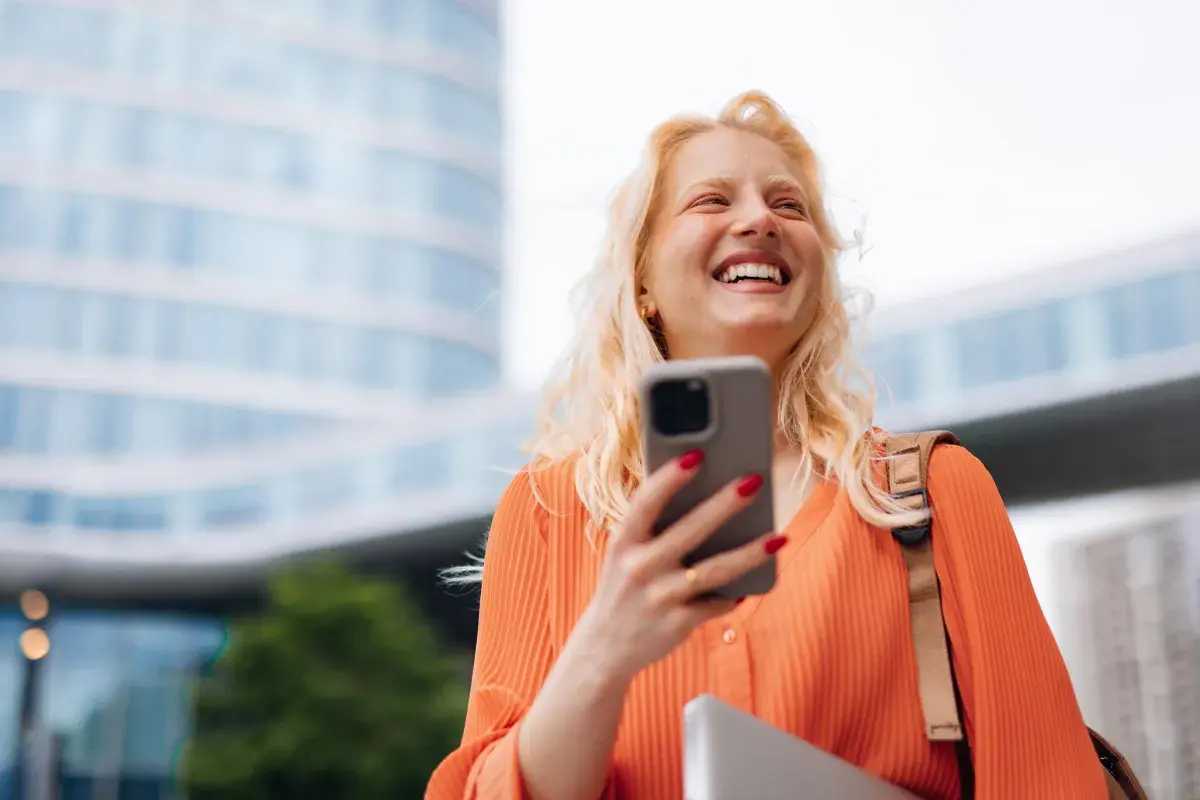 woman smiling looking at phone